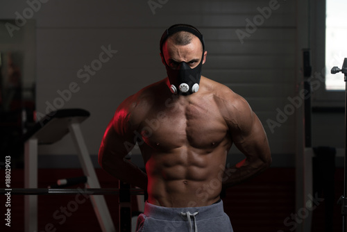 Muscular Man Flexing Muscles In Elevation Mask
