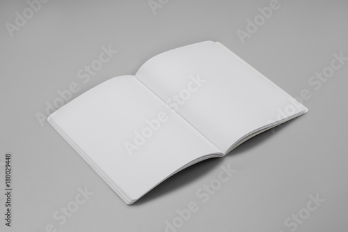 Mock-up magazine, book or catalog on gray table. Blank page or notepad on solid background. Blank page or notepad for mockups or simulations.