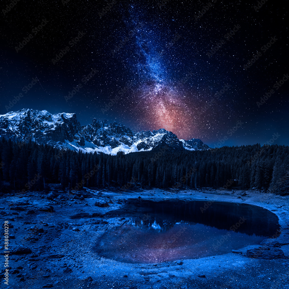 Milky way and Carezza lake in Dolomites at night, Italy