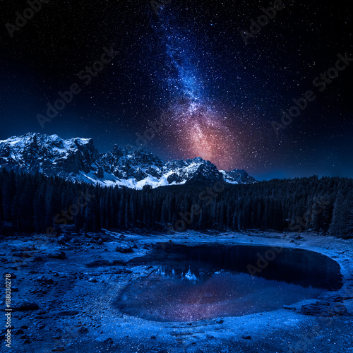 Milky way and Carezza lake in Dolomites at night, Italy