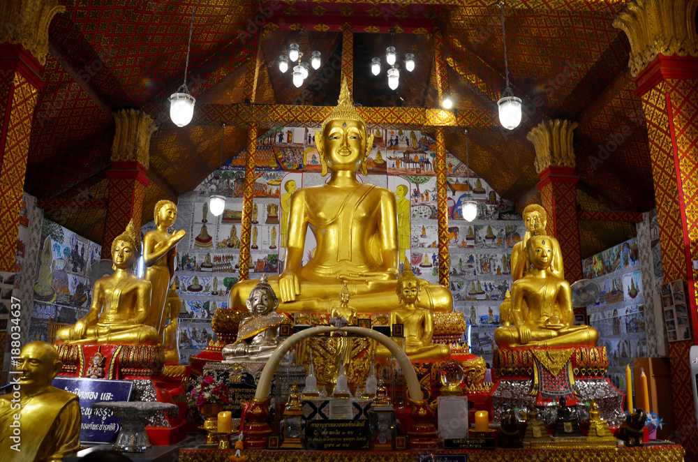 Golden Big Buddha statue for people praying and respect for blessing in ubosot at Wat Tha Sung in Uthai Thani, Thailand