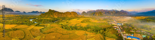 Fototapeta Naklejka Na Ścianę i Meble -  Aerial view of the fields, river and mountain. Beautiful landscape panorama. Laos.