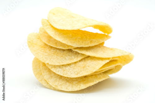 Fried yellow potato chips isolated on white background .