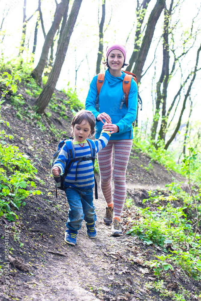 The boy and his mother are walking through the woods. The boy and his mother are walking through the woods.