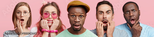 Surprised and nervous multiethnic people look directly into camera, being horrified as finds out some news, isolated over pink background. Worried people pose in studio. Dark skinned male and friends
