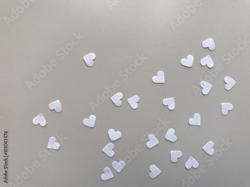 heart shape white papers on light gray leather, using for background, "valentine's day” concept