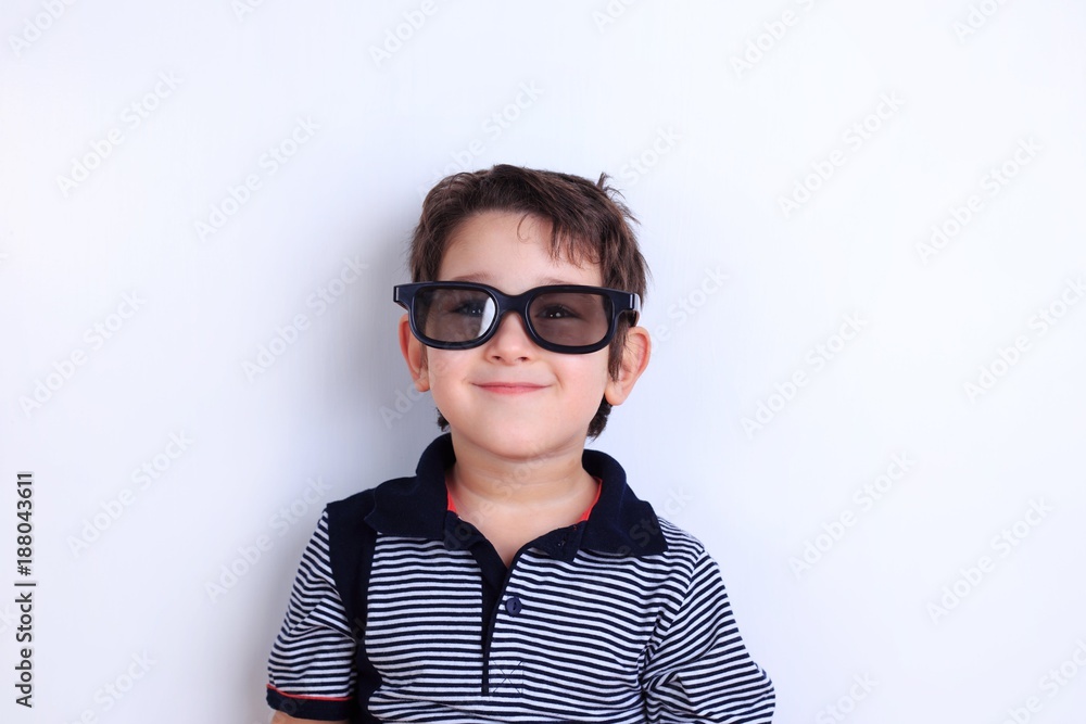 Happy lovely smiling boy in sunglasses, studio shoot on white. Children, fashion and lifestyle concept Happy lovely smiling boy in sunglasses, studio shoot on white. Children, fashion and lifestyle concept
