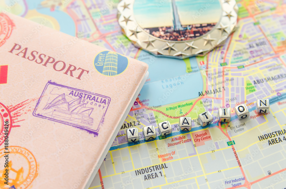 Word vacation and passport on city map UAE