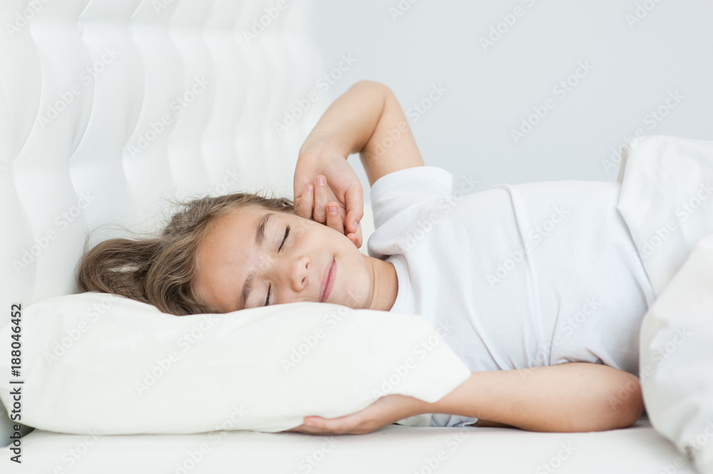 Happy girl stretching in bed after wake up Happy girl stretching in bed after wake up