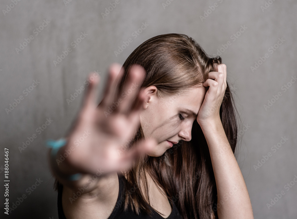 teenage girl showing a stop sign, wanting to be left alone teenage girl showing a stop sign, wanting to be left alone