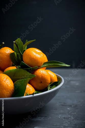 Mandarines on the rustic wooden background. Selective focus. Shallow depth of field.