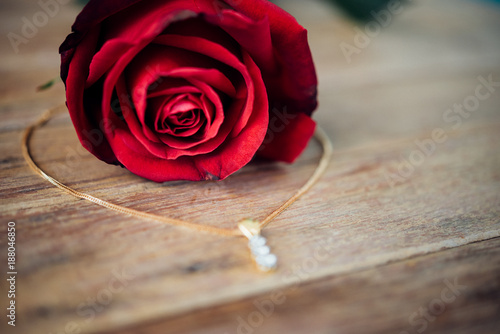 Red rose flower on wooden floor in Valentine's Day