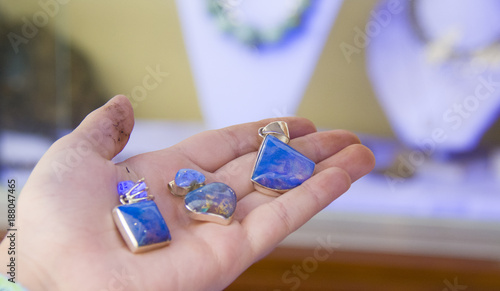 three blue amber pendants, in the ultraviolet light