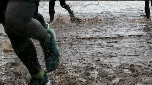 Runners In Water and Mud In Obstacle Endurance Race Slow Motion