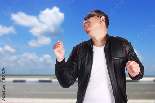 Young Asian Man Dancing Happily photo