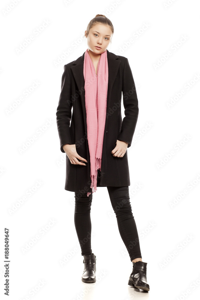 young girl in winter clothes posing on a white background young girl in winter clothes posing on a white background