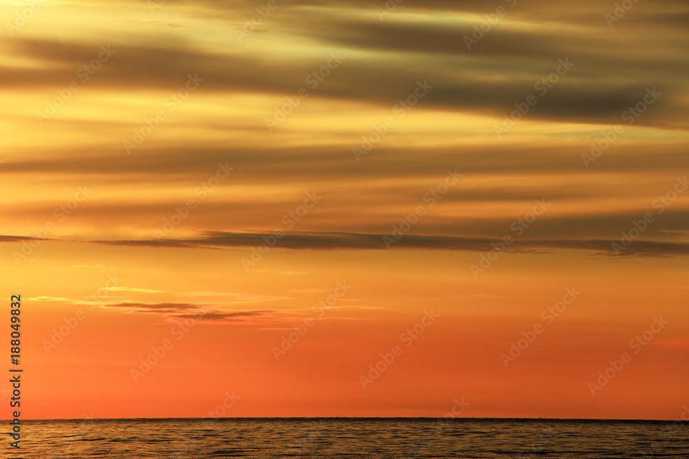 Colorful sunset over the Baltic Sea shore and beach in Rowy, Poland