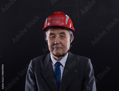pensioner in a construction helmet © serikbaib