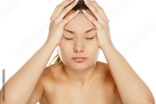 young girl with migraine on white background