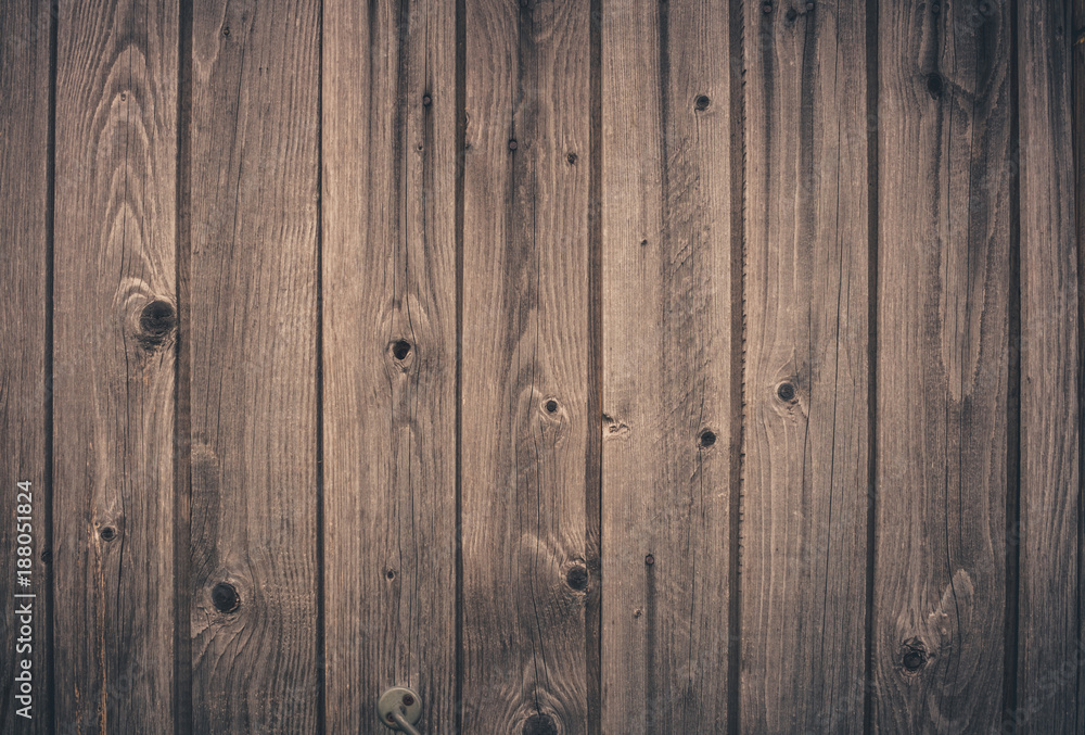 Naklejka premium Wooden retro background of old vertical boards with knots.