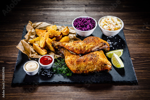 Grilled chicken legs with French fries and vegetables