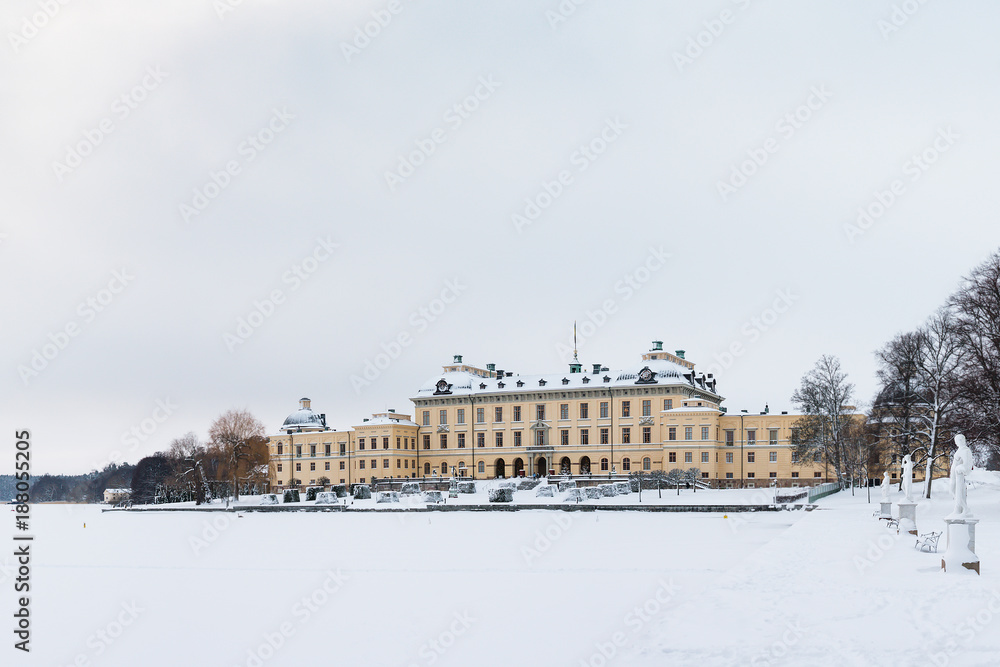 View over Drottningholm Palace and lake on a winter day. Home residence of Swedish royal family. Famous landmark and tourist destination in Stockholm, Sweden