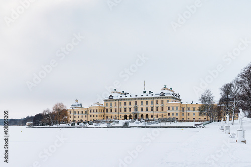 View over Drottningholm Palace and lake on a winter day. Home residence of Swedish royal family. Famous landmark and tourist destination in Stockholm, Sweden
