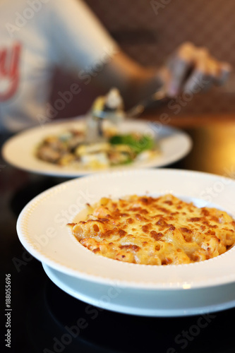 Baked Macaroni and cheese with shrimp dish. Italian food style.