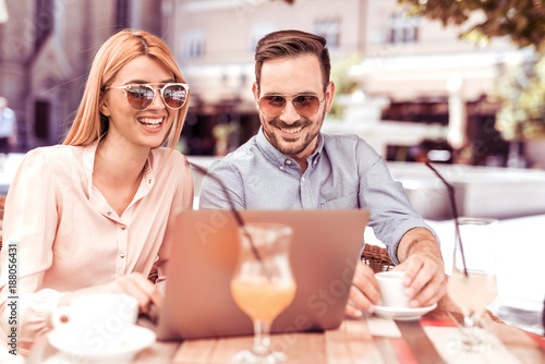 Couple using tablet computer in coffee shop.