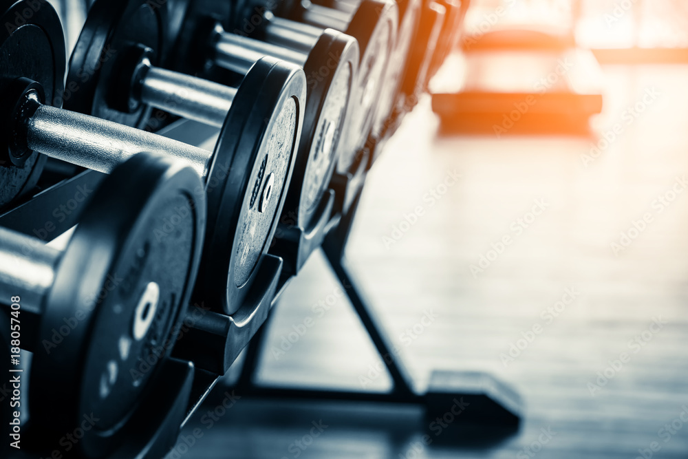 Rows of dumbbells in the gym with hign contrast and monochrome color tone Rows of dumbbells in the gym with hign contrast and monochrome color tone