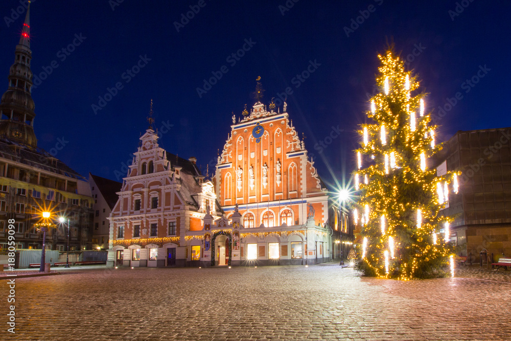 Riga, Latvia. Panorama Of Town Hall Square, Popular Place With Famous Landmarks On It In Bright Evening Illumination In Winter Twilight. Winter New Year Christmas Holiday Season.