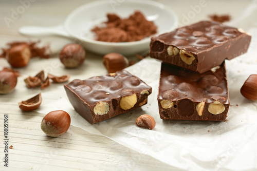 chocolate bar with hazelnuts on white table