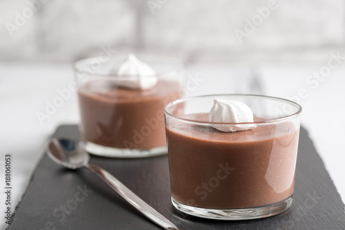 Chocolate mousse in a glasses on a black stone background. photo