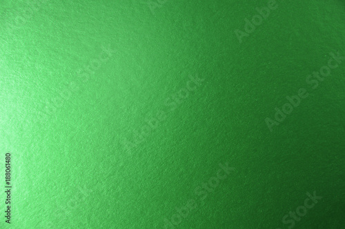 Texture of green metallic paper background for design Christmas or New Year's party cards