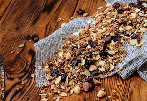 Background with dry muesli on old wooden desk photo