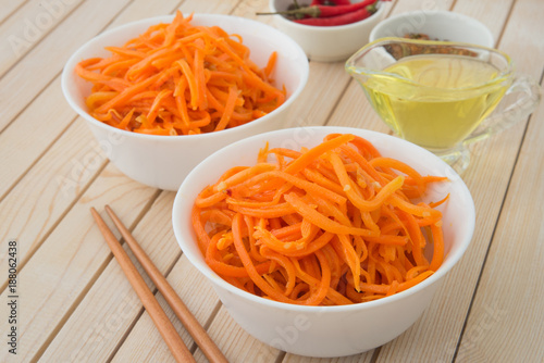 Spicy korean carrot calad in white plates
