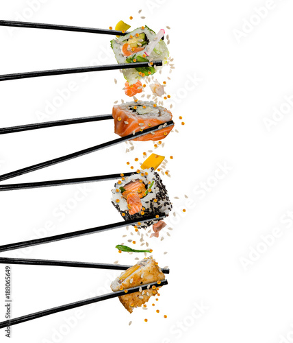 Pieces of sushi with wooden chopsticks, separated on white background.