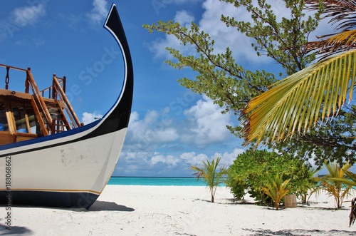 Beautiful Maldives Beach With A Dhoni traditional boat, Lonubo atoll. photo