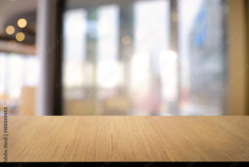 Empty wooden table in front of abstract blurred background of coffee shop . can be used for display or montage your products.Mock up for display of product. Empty wooden table in front of abstract blurred background of coffee shop . can be used for display or montage your products.Mock up for display of product.