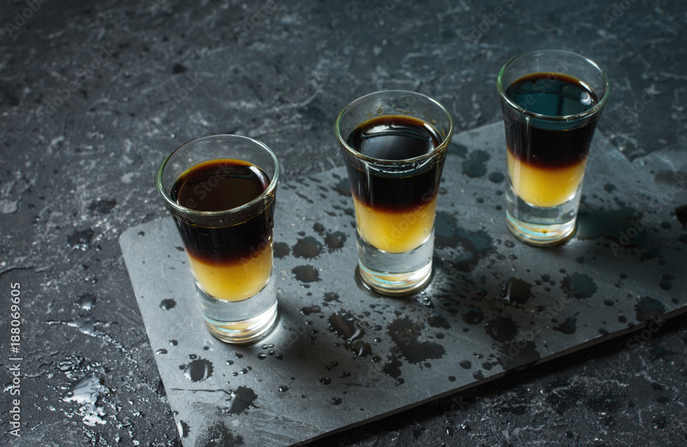 Black Shooter - Black Balsam and peach juice. Hard alcoholic shots on stone table