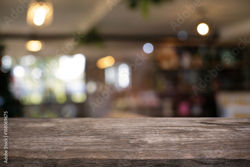 Empty wooden table in front of abstract blurred background of coffee shop . can be used for display or montage your products.Mock up for display of product.