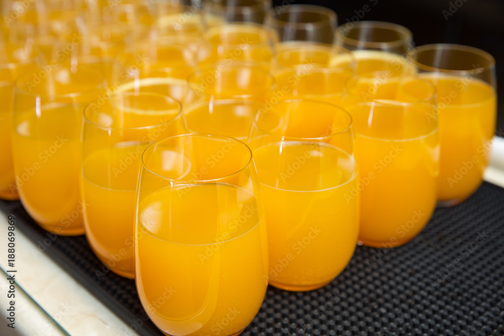 Row of Glasses with Fresh Orange Juice on a table/ Catering concept. Selective focus, Row of Glasses with Fresh Orange Juice on a table/ Catering concept. Selective focus,