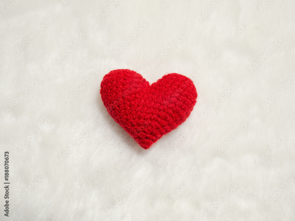 handmade red yarn heart on white wool. the red heart on the center of picture and background copy space for text. Valentines day, love concept and love background