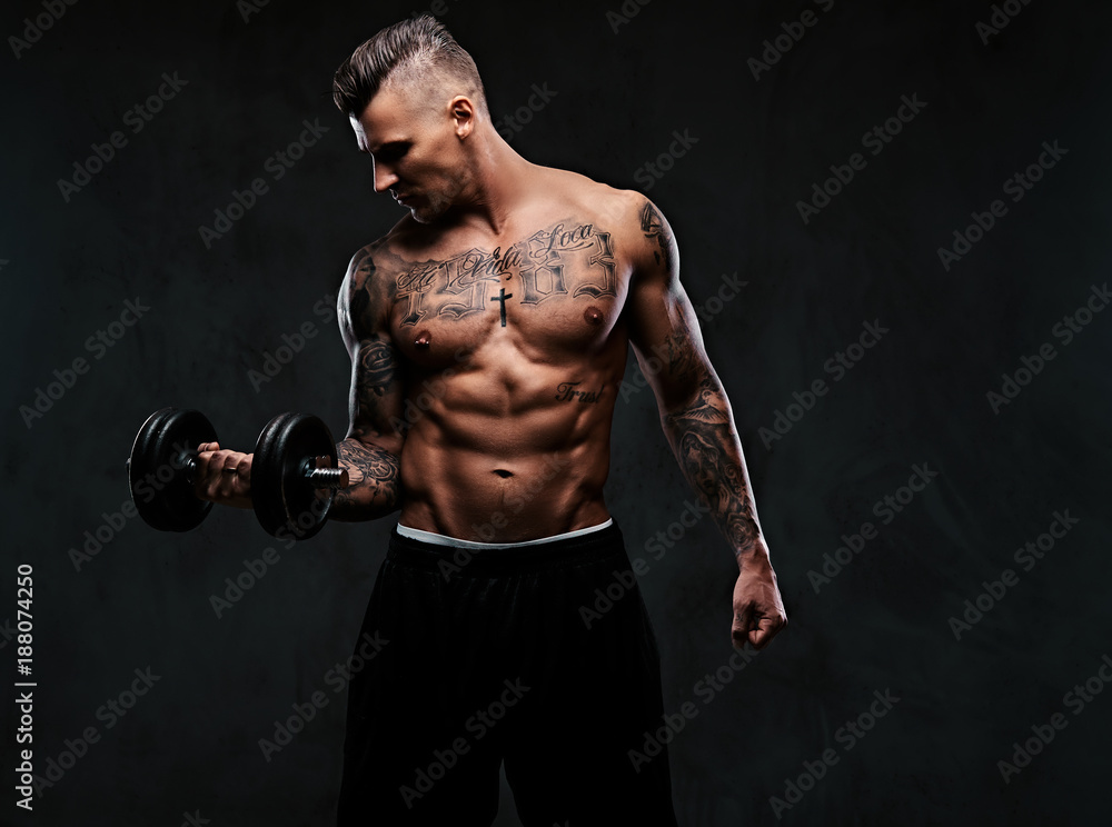 A muscular man doing exercises with dumbbells.