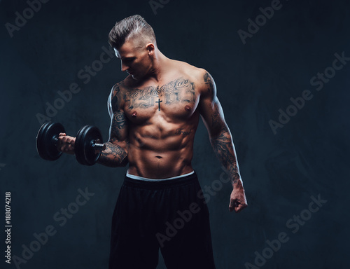 A muscular man doing exercises with dumbbells.