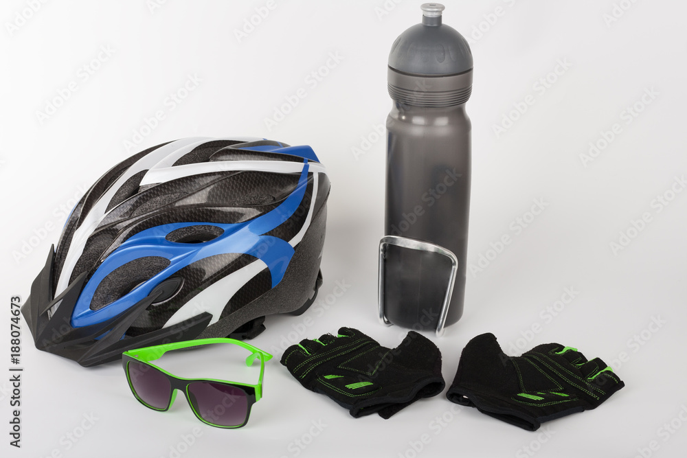 Obraz premium Bike accessories, bike helmet, bike gloves, eyeglasses and water bottle in holder