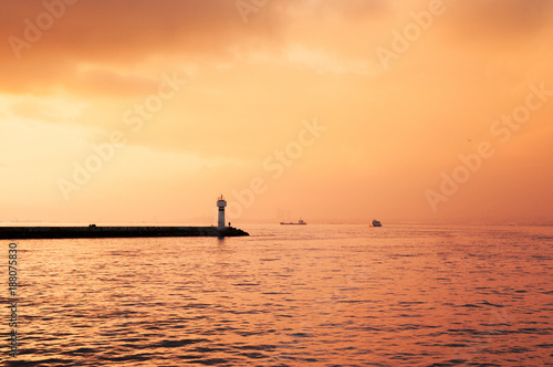 Small lighthouse and beautiful sunset sky on a cloudy day