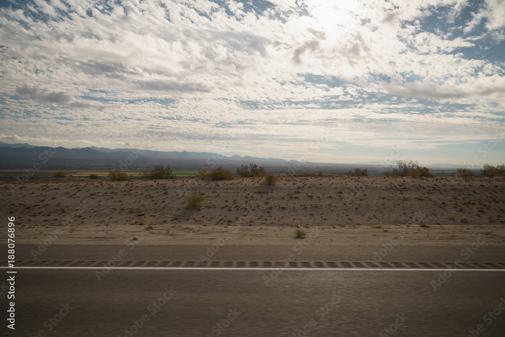 highway through Nevada desert in sunny autumn day