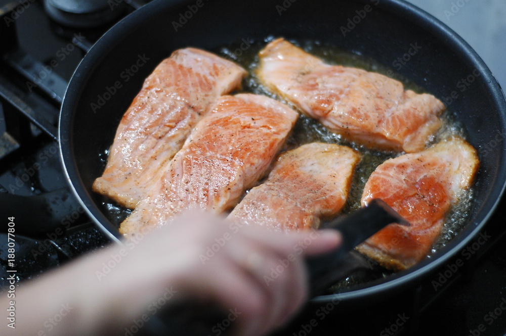 large steak of salmon is fried in sunflower oil. large steak of salmon is fried in sunflower oil.