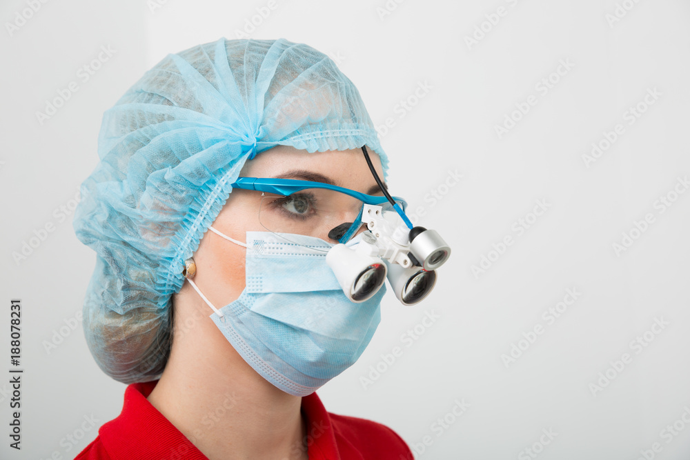 Portrait of serious surgeon in scrubs googles and mask that posing on camera Portrait of serious surgeon in scrubs googles and mask that posing on camera